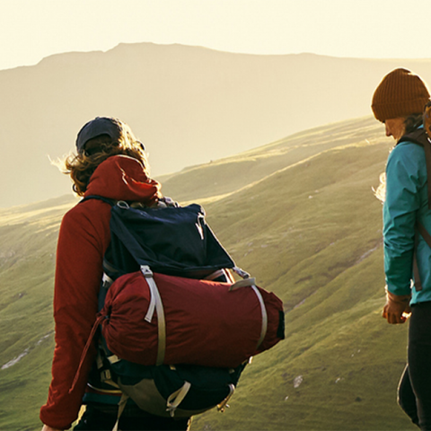 Shot of a young couple hiking through the mountains.