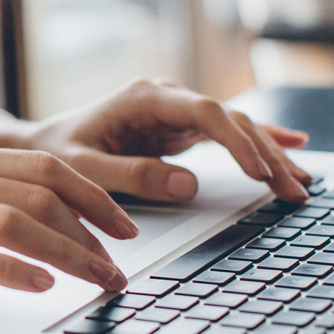 Woman working on laptop.