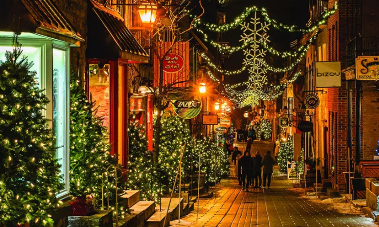Quebec street in the evening at christmas time with christmas trees and lights