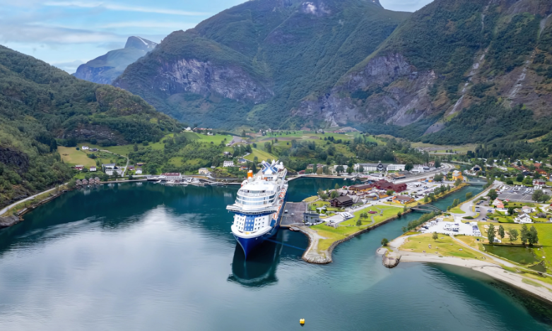 Celebrity Cruise ship at port call in Scandinavian country with mountains in background