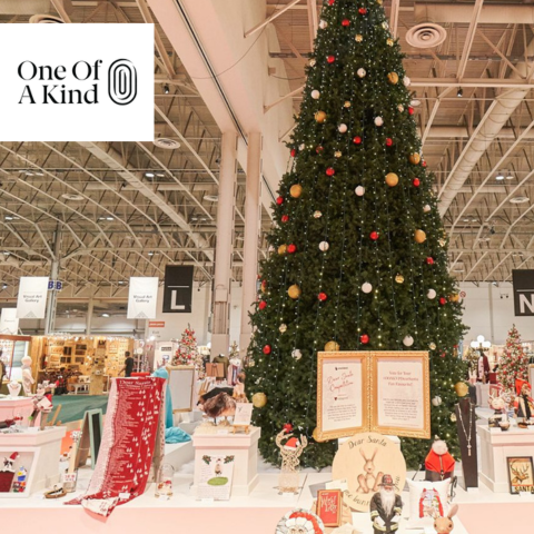 Inside the Enercare Center in Toronto at the One of a Kind Winter Show with a Christmas tree on display and vendors selling holiday gifts