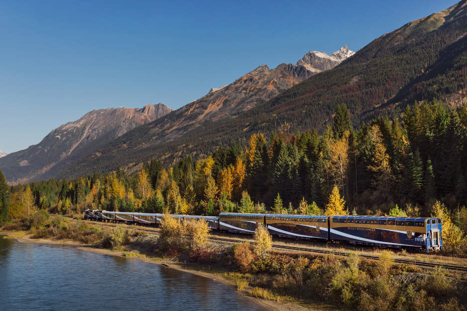 Rocky Mountaineer travelling along the water on Journey through the Clouds