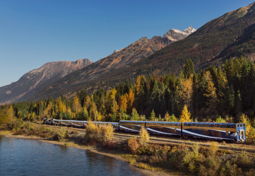 Rocky Mountaineer travelling along the water on Journey through the Clouds