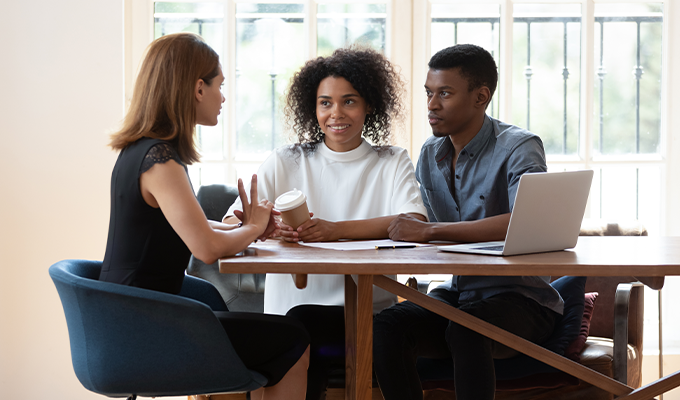 Couple talking with an insurance advisor