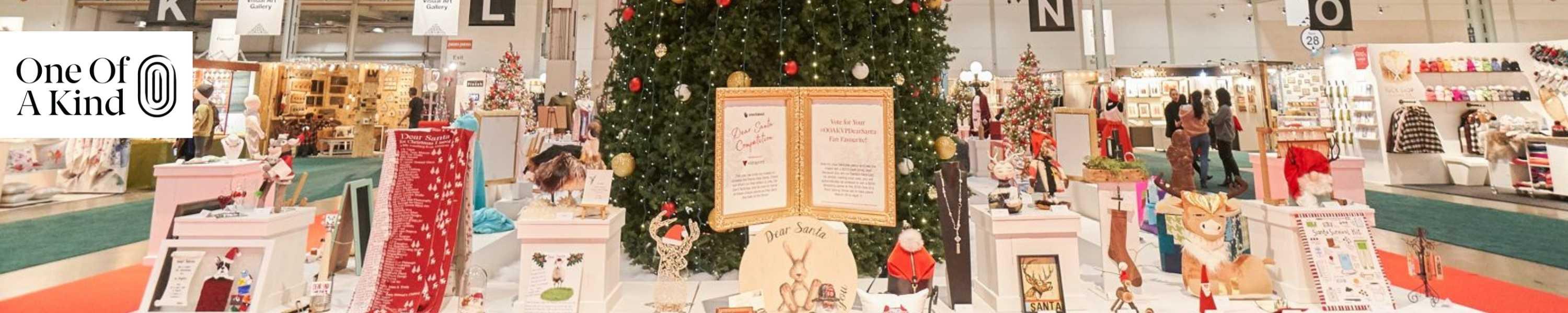 Inside the Enercare Center in Toronto at the One of a Kind Winter Show with a Christmas tree on display and vendors selling holiday gifts